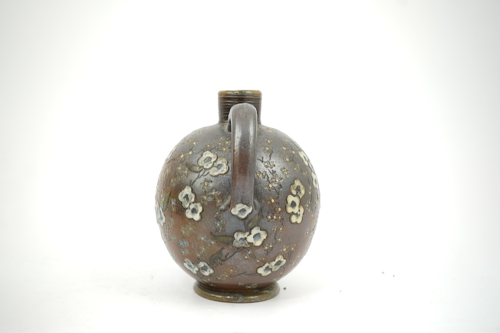 Martin Brothers: A stoneware jug decorated with flowers